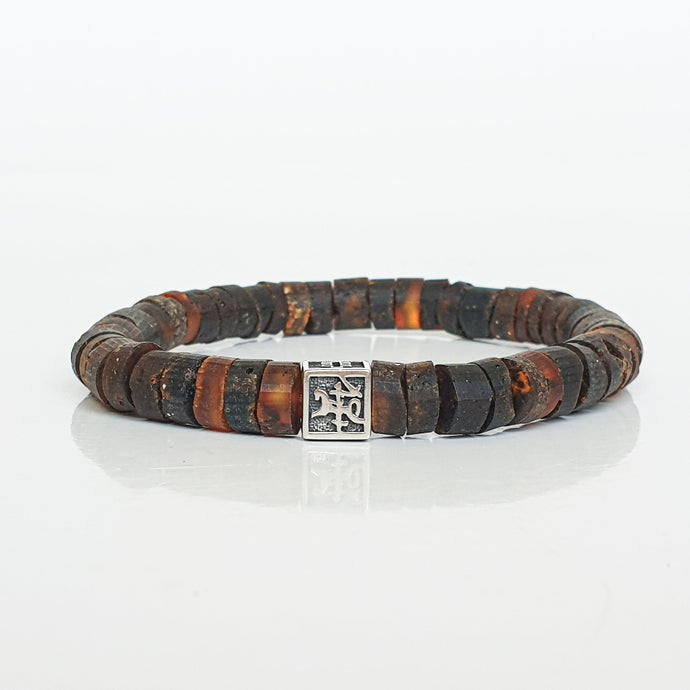 Bracelet with brown and black beads Baltic amber and a silver clasp on a white background