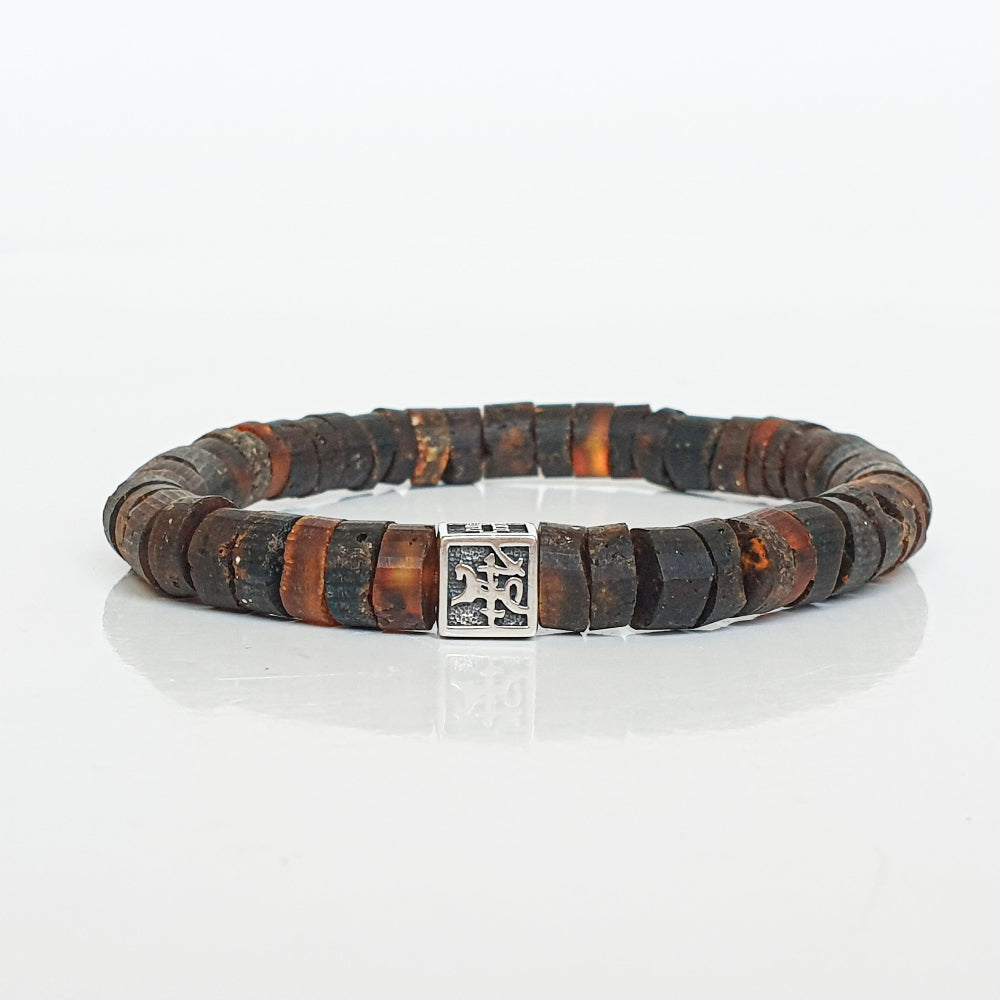 Bracelet with brown and black beads Baltic amber and a silver clasp on a white background