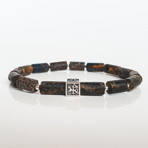 Bracelet with brown Baltic amber beads and a silver Vytis on a white background