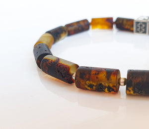 Close-up of a tortoiseshell beaded bracelet on a white background