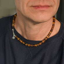 Load image into Gallery viewer, Close-up of a person wearing a beaded necklace with a dark shirt.