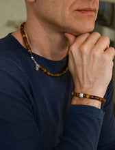 Load image into Gallery viewer, Man wearing a necklace and bracelet with a blurred background