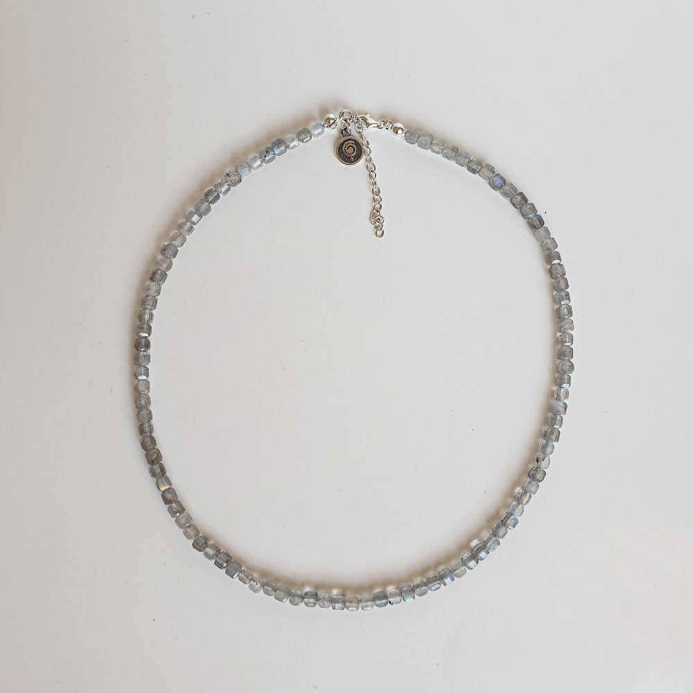 Necklace with small beads on a light gray background